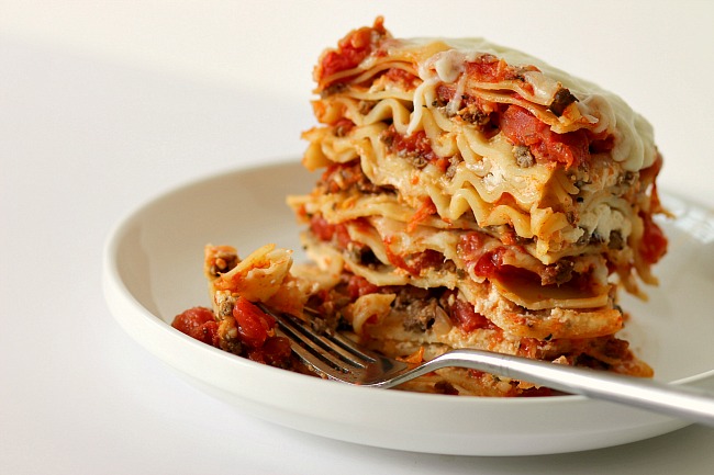 Carrabba's lasagna copycat recipe on a plate with a fork.