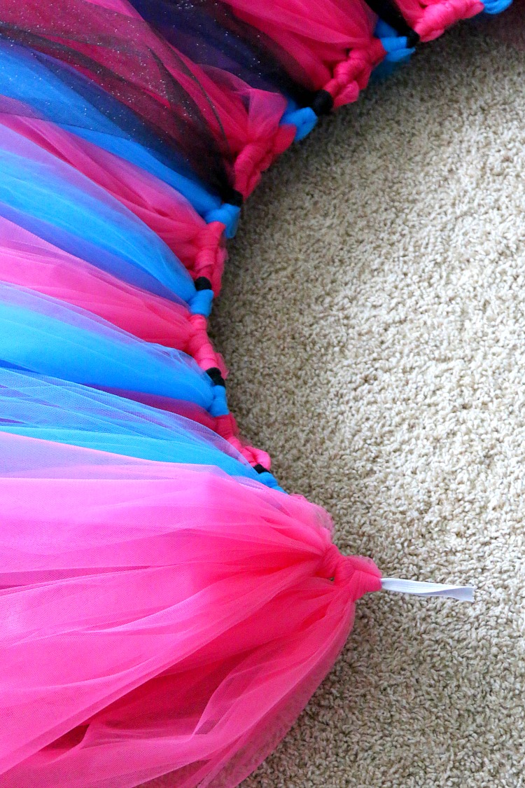 A piece of elastic serves as the waistband for a tulle tutu skirt with big strips of tulle looped on it for fullness.