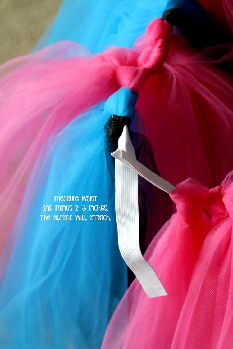 Up close view of an elastic waistband with pink and blue tulle tied around it to make a no-sew tutu skirt.