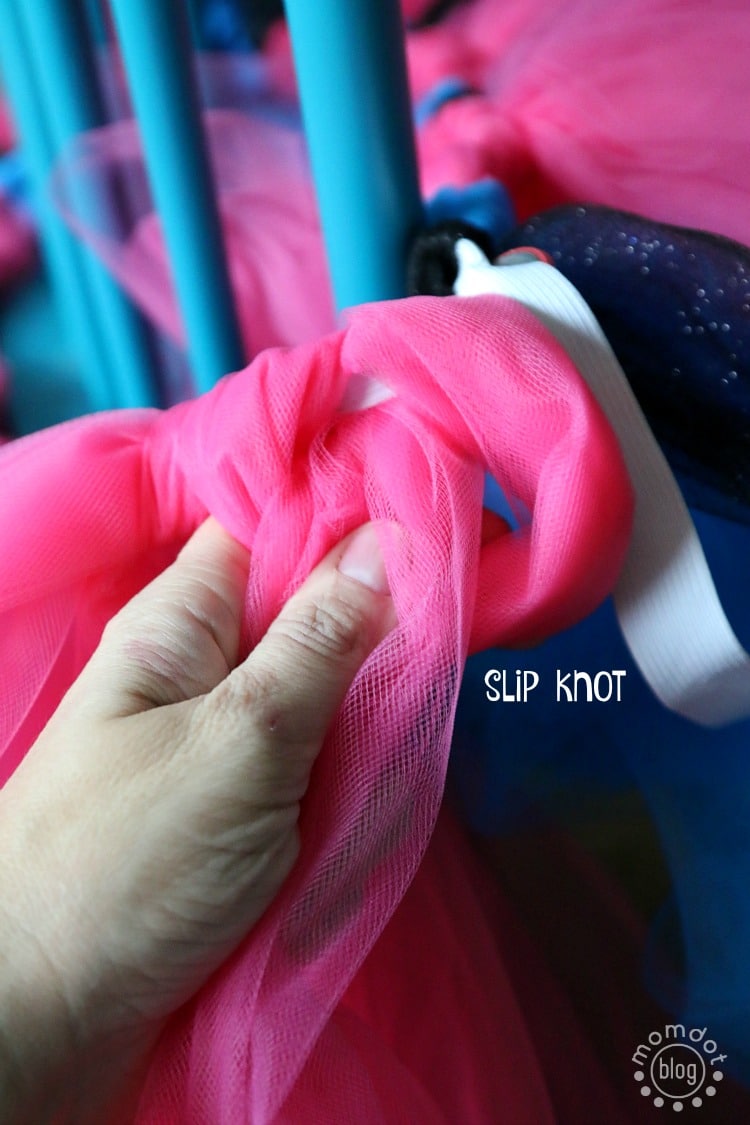 Finish a slipknot of tulle on a DIY tutu skirt by looping the tulle through the big loop that's tucked under the waistband.