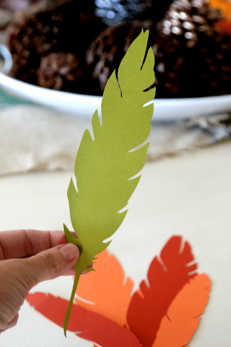 feathers cut from green, orange, and red cardstock using a Silhouette cutting machine