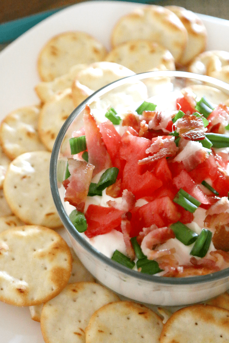 5 minute BLT dip perfect for game day and holiday appetizer in a bowl with water crackers on the side