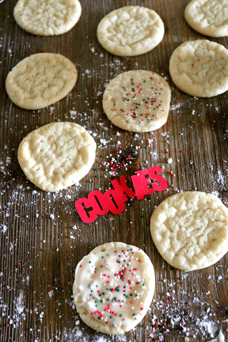 Sugar cookies decorated with 2-ingredient buttercream frosting and red, green, and white sprinkles.