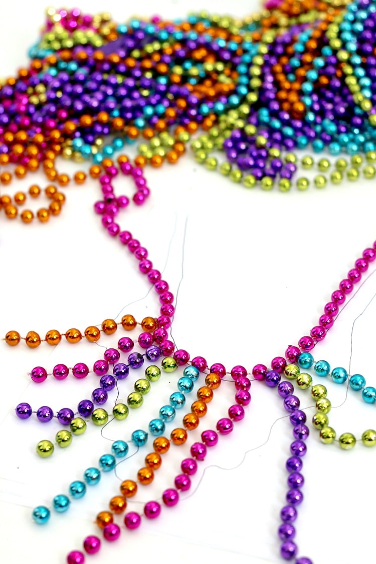 DIY Mardi Gras Flower Necklace: Repurpose your Mardi Gras beads into a statement necklace