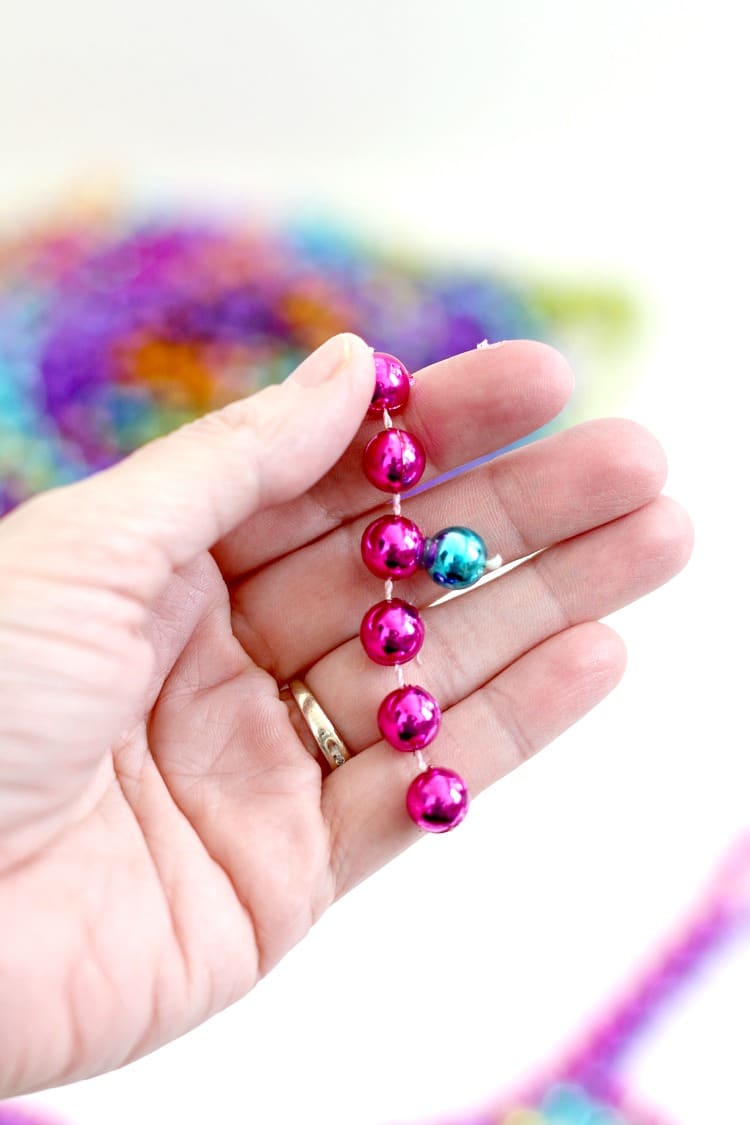 DIY Mardi Gras Flower Necklace: Repurpose your Mardi Gras beads into a statement necklace