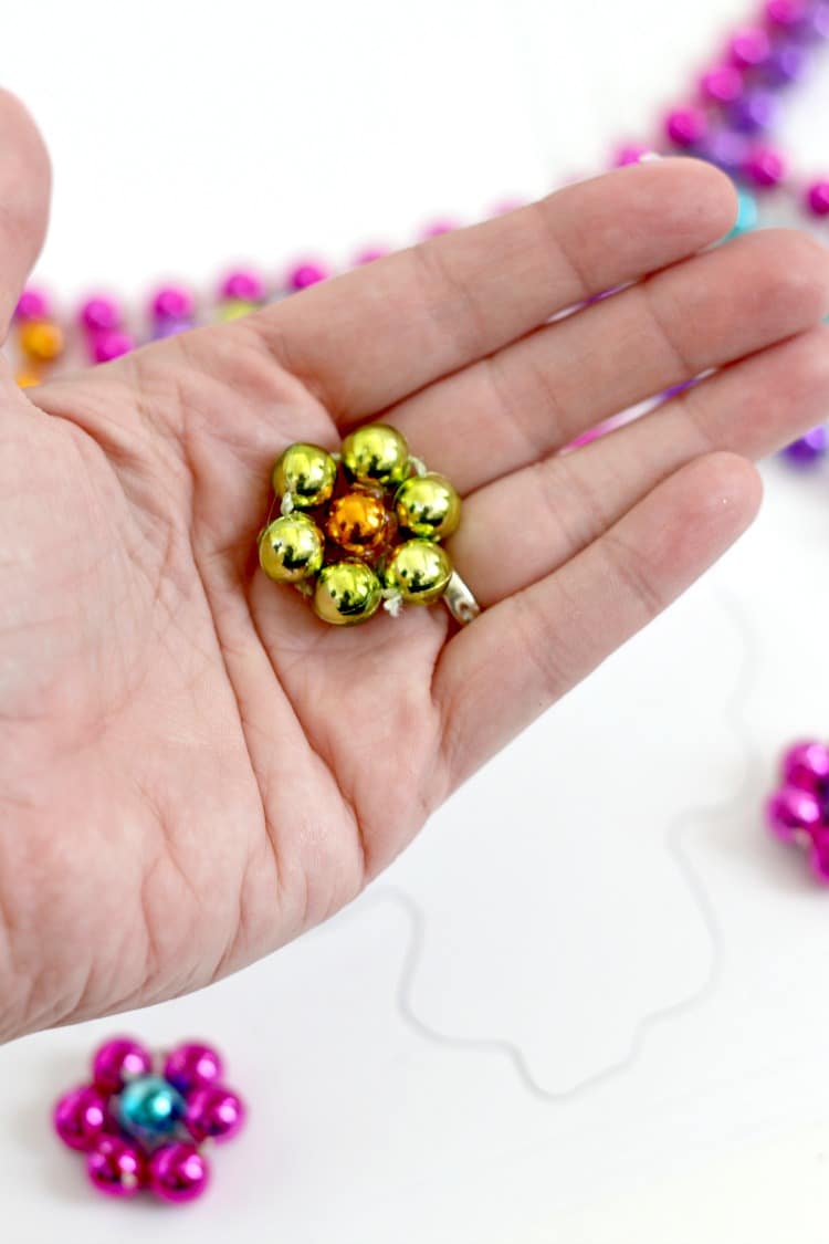 DIY Mardi Gras Flower Necklace: Repurpose your Mardi Gras beads into a statement necklace