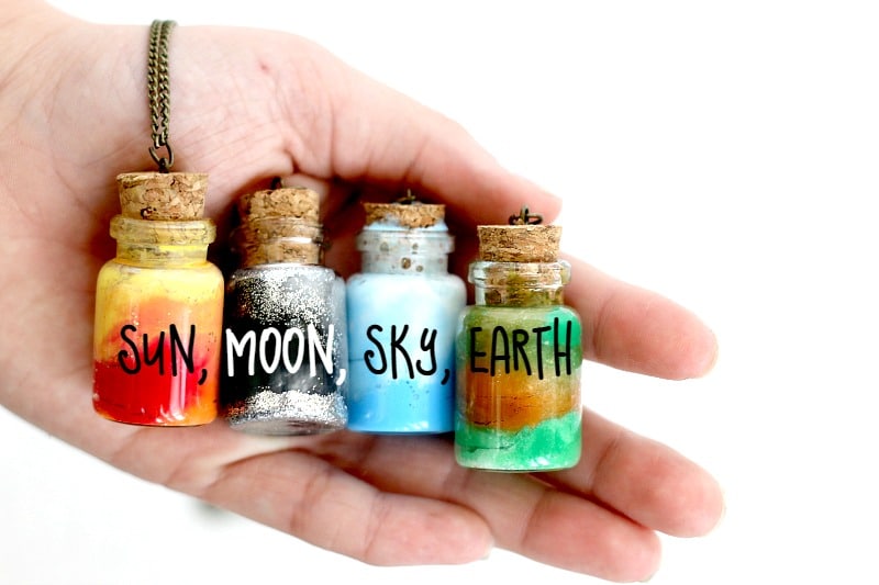 Element Jars Necklaces with red and yellow for sun, black and silver for moon, blue and white for sky, and brown and green for earth.