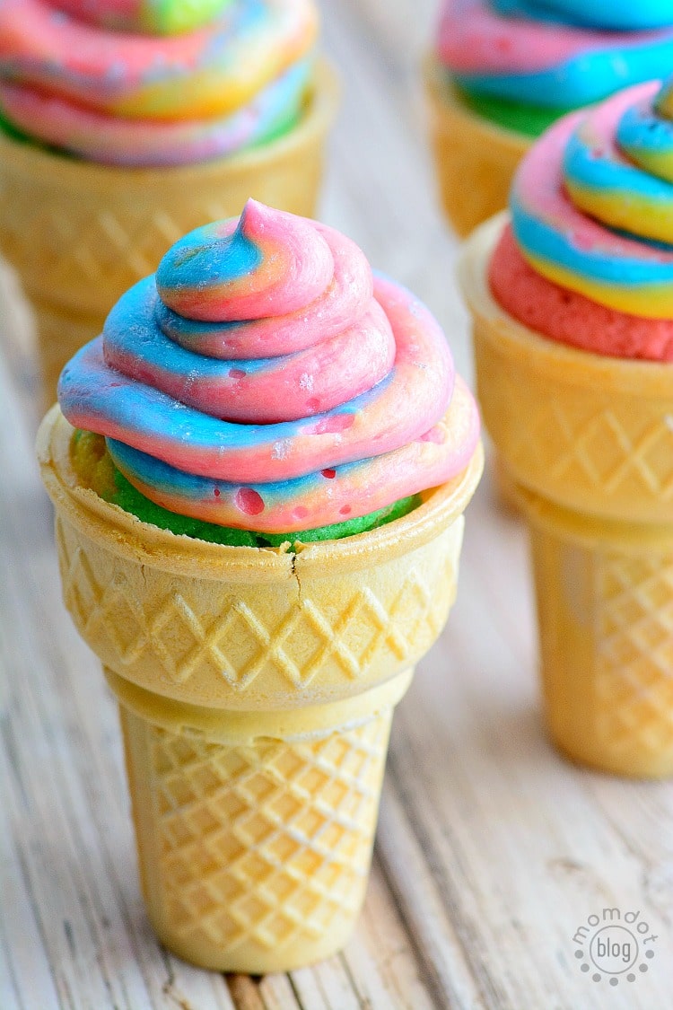 Unicorn poop cupcakes baked in ice cream cones with perfectly swirled colored frosting.