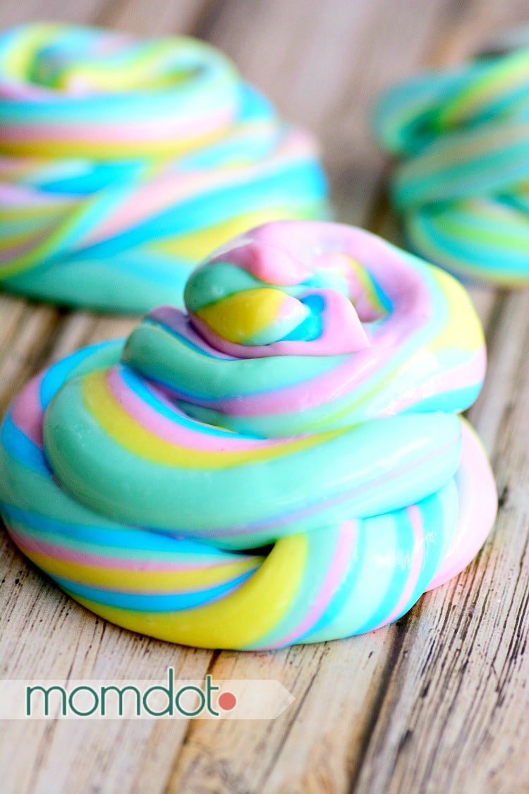 Unicorn poop slime recipe in bright blue, yellow, mint green, and bright pink combined to make rainbow slime.