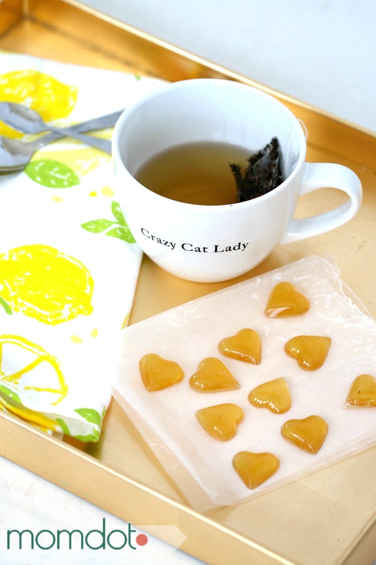 Mug of tea and homemade honey drops candy to sweeten it.