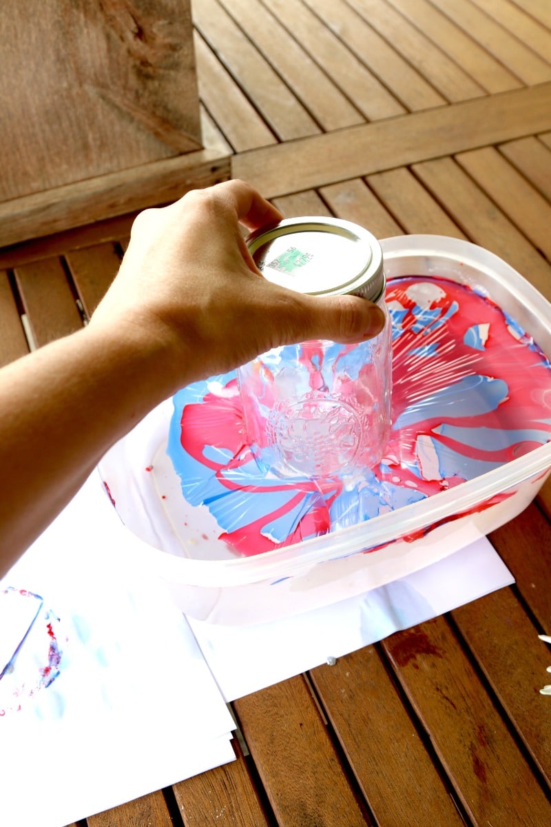 Marble dipping mason jars in nail polish that has floated on top of water too long makes it a dried sheet that won't stick to the glass.