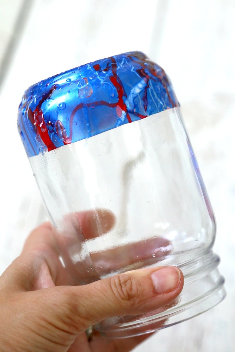 A marble dipped mason jar needs to be dried upside down so the nail polish won't smudge while it cures. 