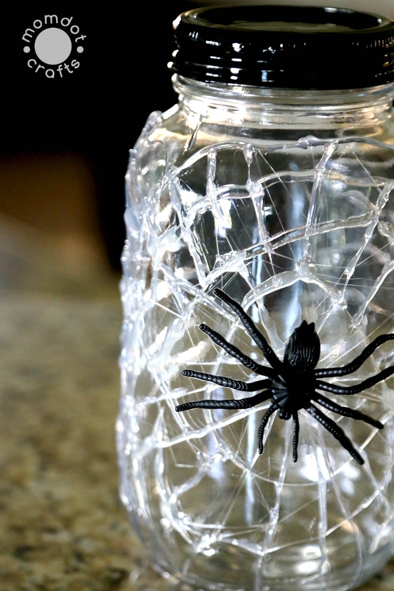 Spider jar with hot glue web and a fake spider