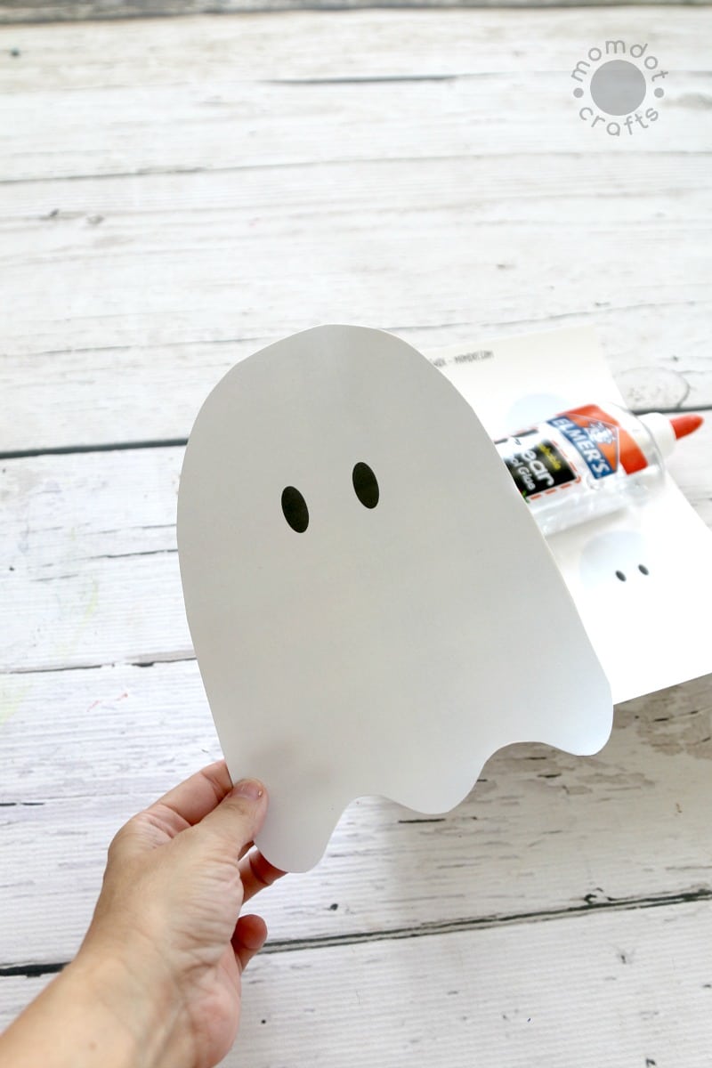 Ghost template cut out with clear school glue to make cotton ball ghosts