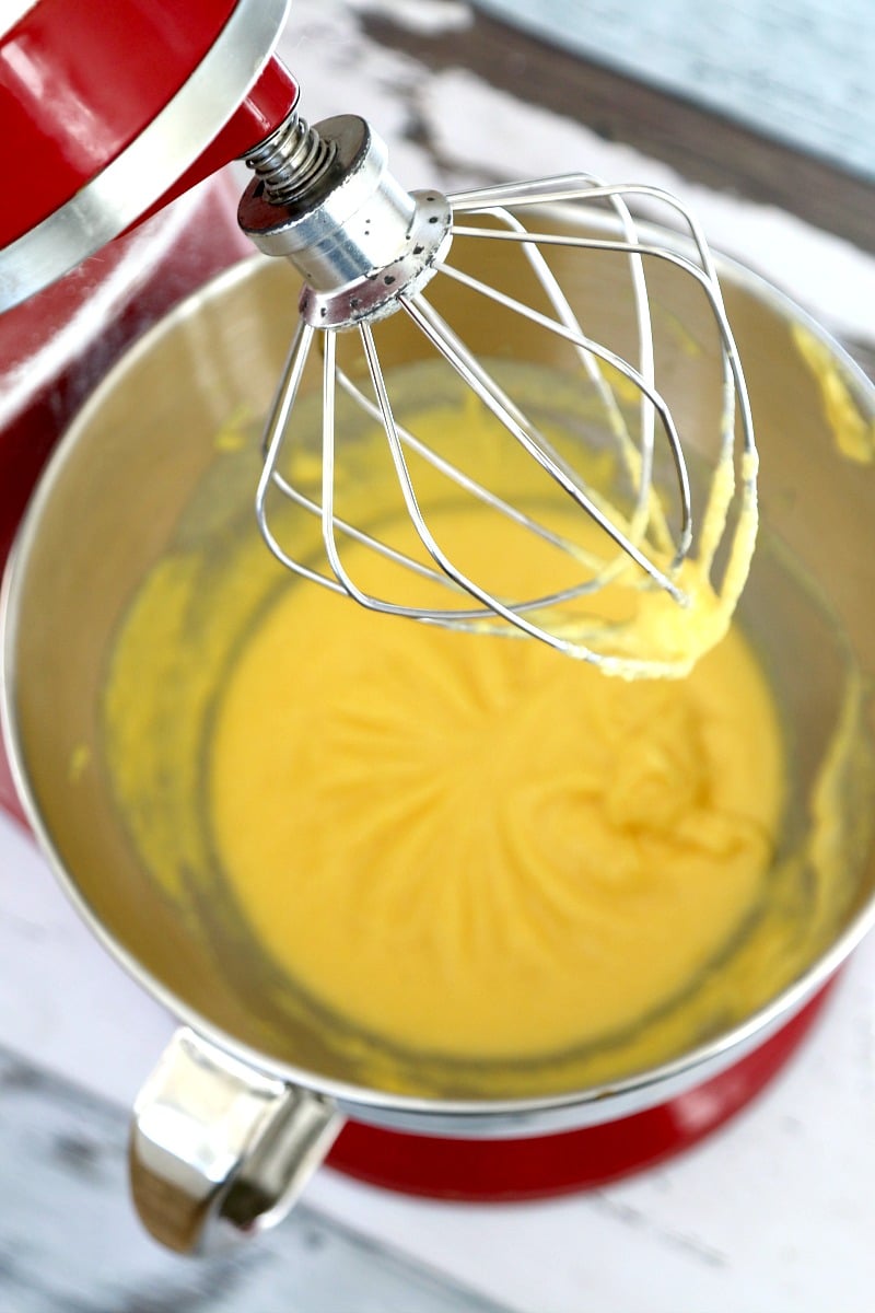 Vanilla pudding in a mixing bowl which is the first step in making eggnog cheesecake