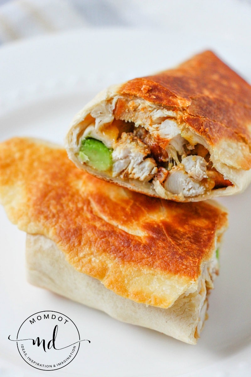 Browned Chicken Avocado Burritos cut in half to show texture and fresh, hot filling.