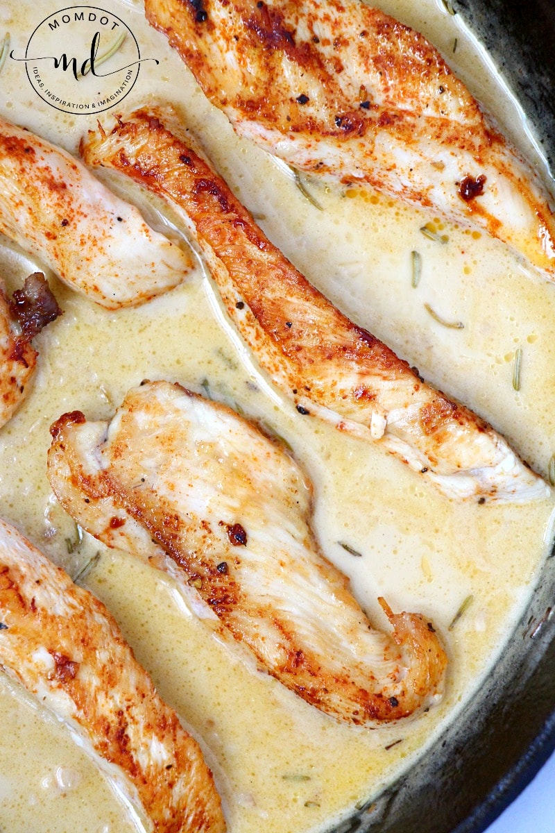 Golden brown seasoned chicken tenders in a garlic lemon sauce