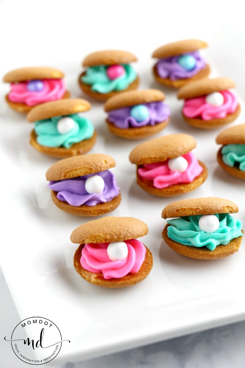 Clam Shell Cookies Made with Nilla Wafers and purple, pink, and green frosting with candy pearls