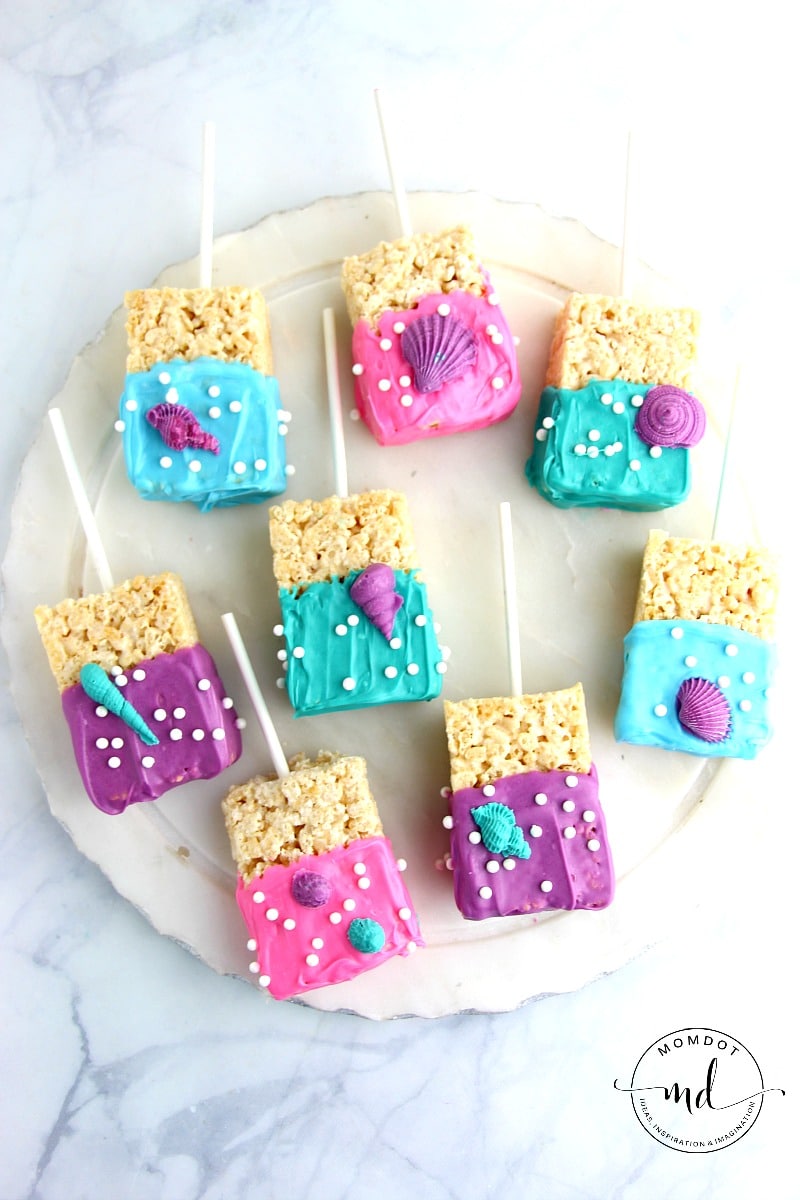 Mermaid Rice Krispie Treats covered with blue, pink, or purple dipping chocolate and sprinkles