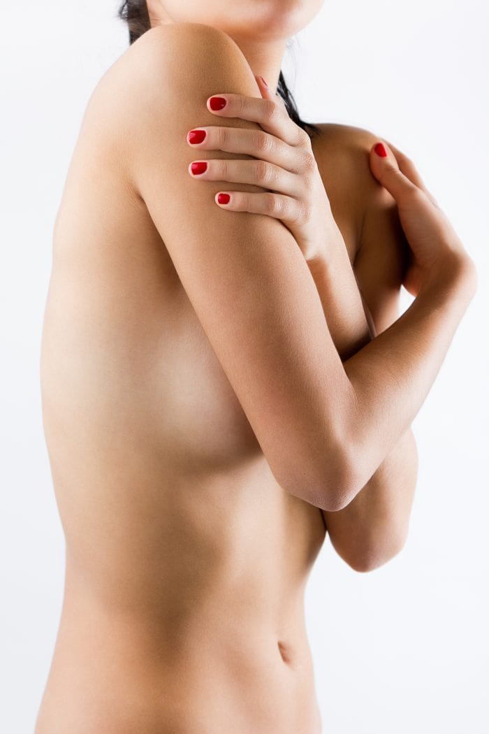 Nude woman showing tummy tuck recovery