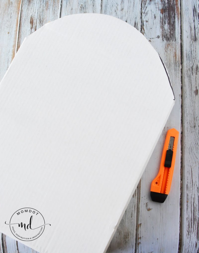 Utility knife and cardboard cutout of a tombstone