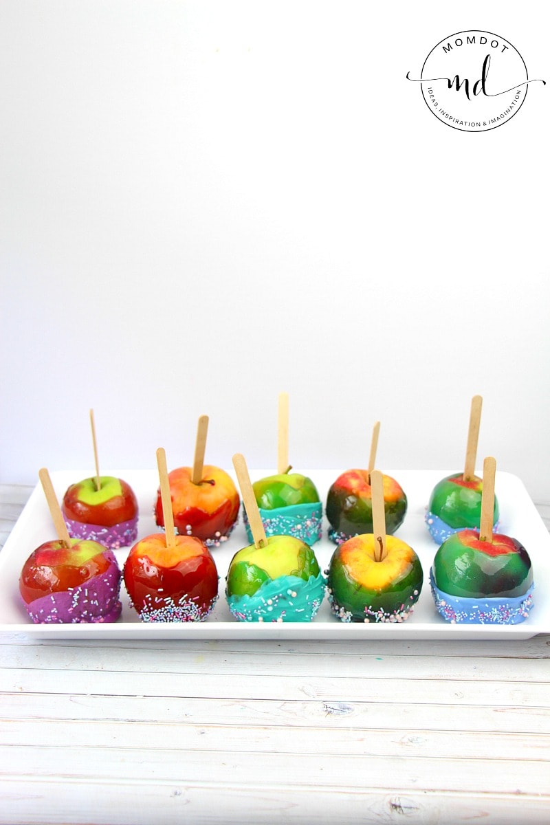 10 Jolly Rancher candy apples on a plate, each dipped in colored chocolate and sprinkles