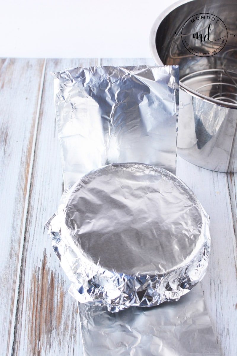 The cheesecake is covered with foil before placing it in the Instant Pot to cook.