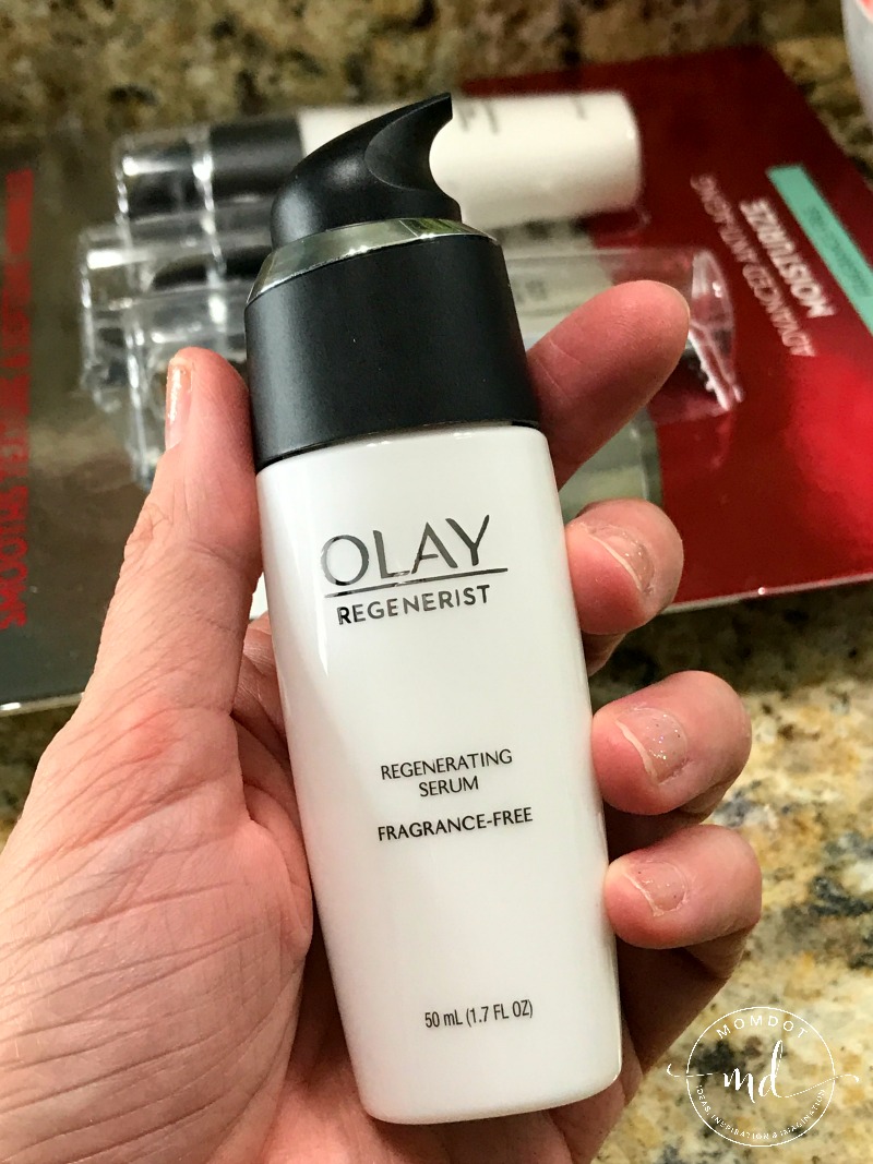 Hand holding a bottle of Olay Regenerist regenerating serum for the face