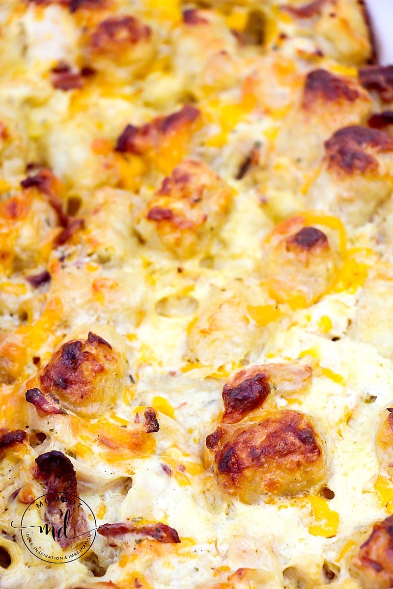 Tater tot casserole that's done baking with a little browned cheese and tater tots on top.