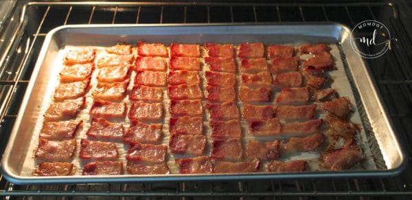 Baking bacon chips in the oven, turning golden brown.