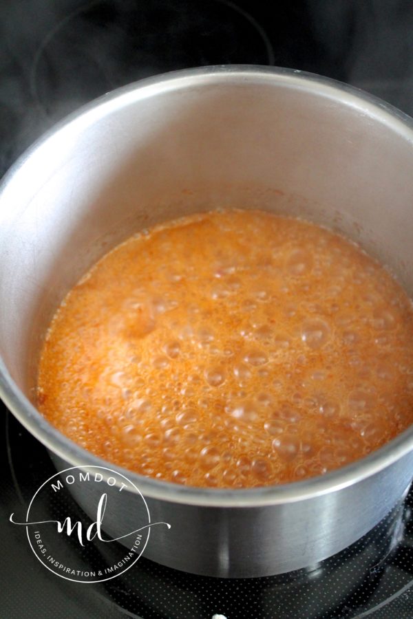 Boiling Asian Zing boneless chicken wing sauce so it will thicken.
