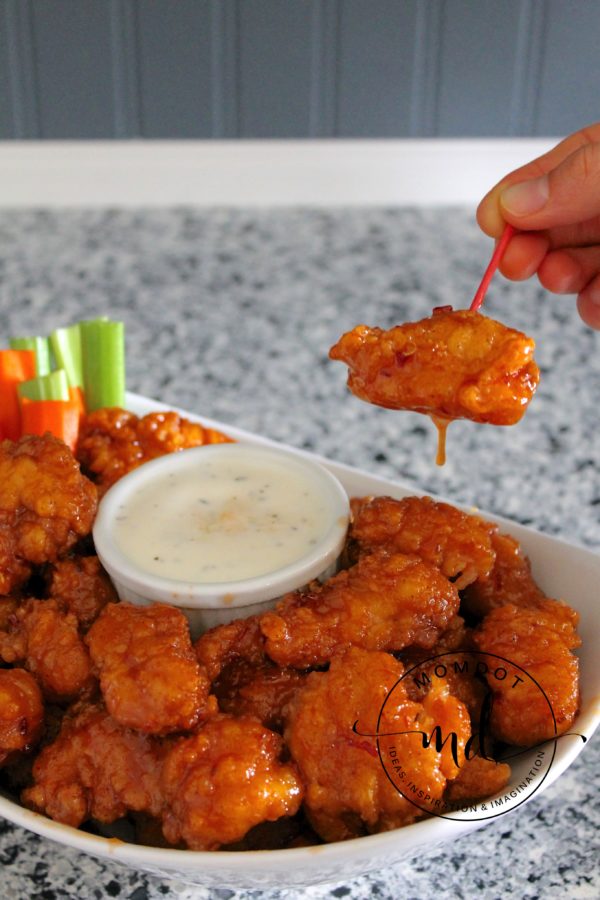 Asian Zing copycat recipe boneless chicken wings in a bowl with ranch dressing to cool down.
