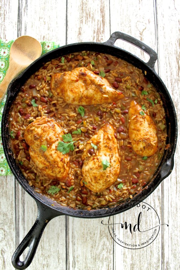 Skillet with finished Red Beans & Rice With Chicken recipe topped with fresh cilantro.