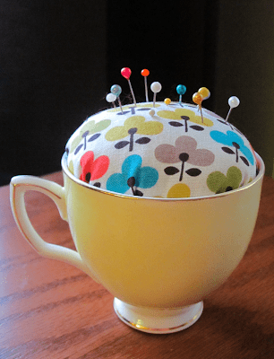 A DIY gift for mom that's a vintage teacup that's been made into a pincushion.