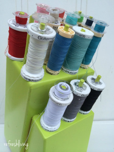 An old knife block that's upcycled into a thread holder with pegs - the perfect DIY gift for a mom who sews.