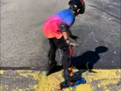 A child learning to skate with Roller Derby Tracer inline skates